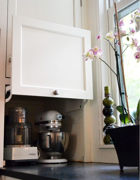 https://theorganisedhousewife.com.au/wp-content/uploads/2014/07/clever-kitchen-cabinet-appliance-storage-1.jpg