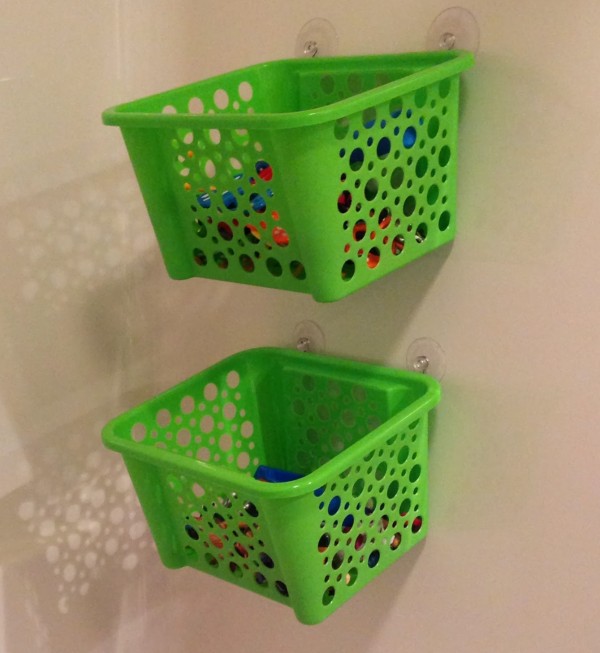 Use a shower rod and dollar store baskets to keep bath toys organized.