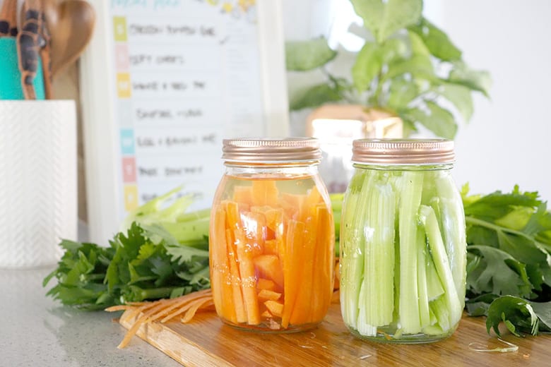 Carrot and celery stored in mason jars for freshness
