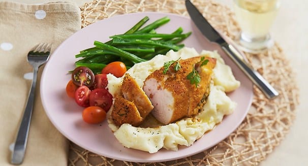 Chicken Kiev with mashed potato and greens