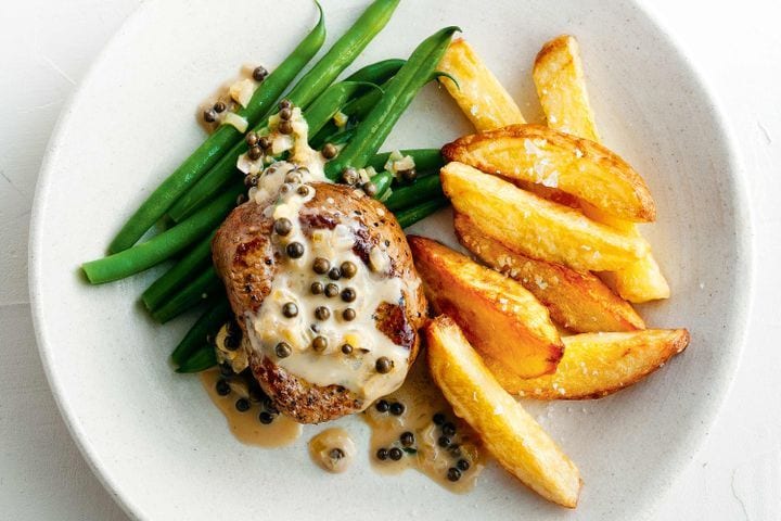 Pepper sauce steak with over baked chips and green beans