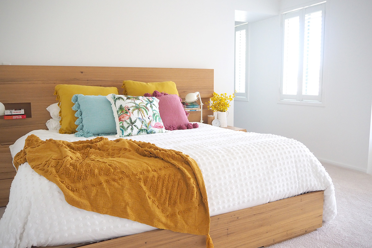 Winter bedroom with throw and plantation shutters