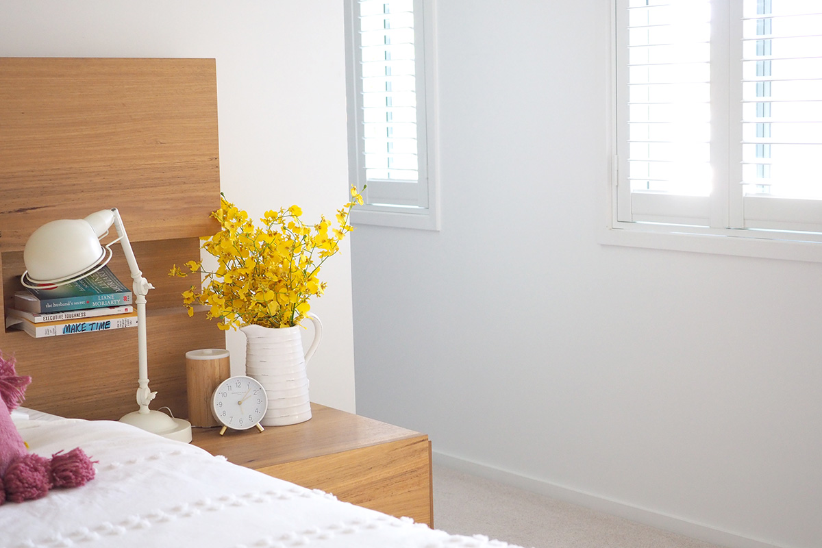 White linen, flowers and plantation shutters