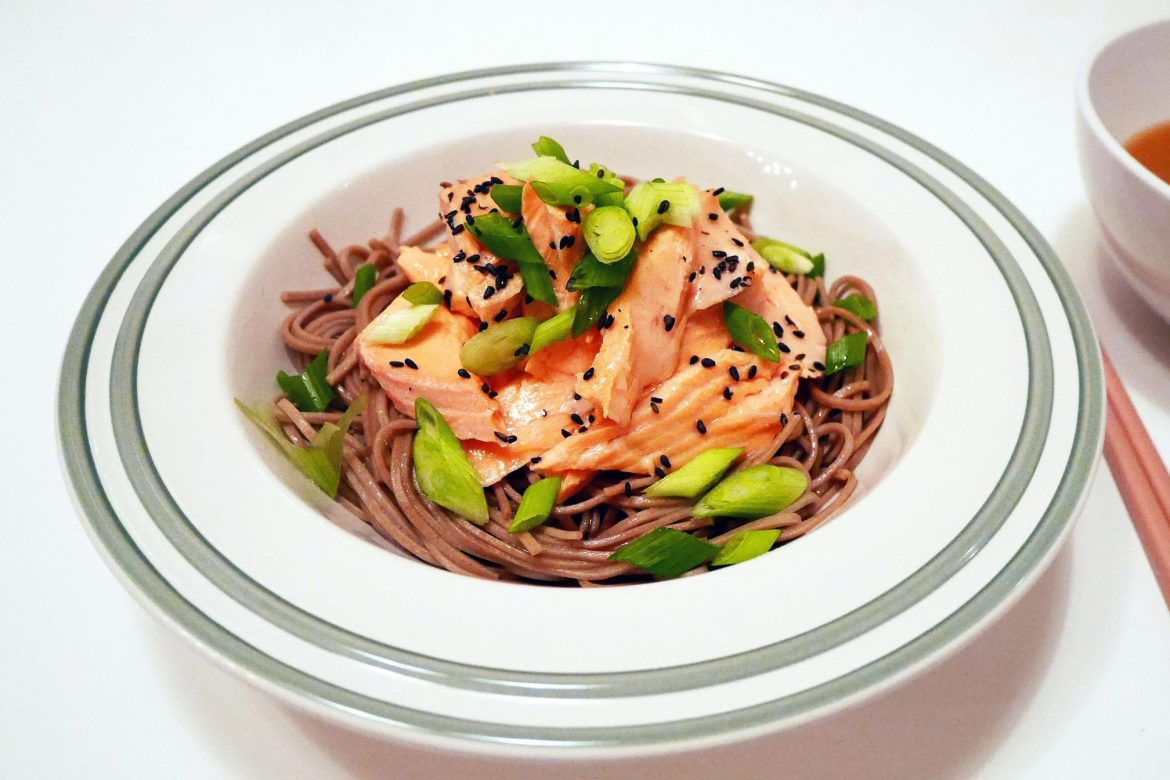 soba noodles with salmon, olives topped with black sesame seeds