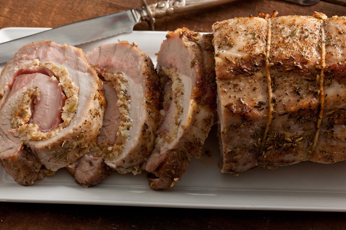 stuffed pork loin wrapped with string, topped with herbs of fennel