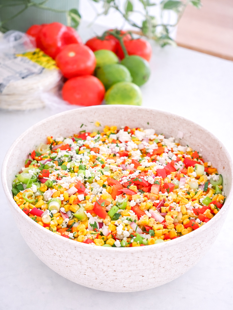 Corn salad with tomato, capsicum, and feta